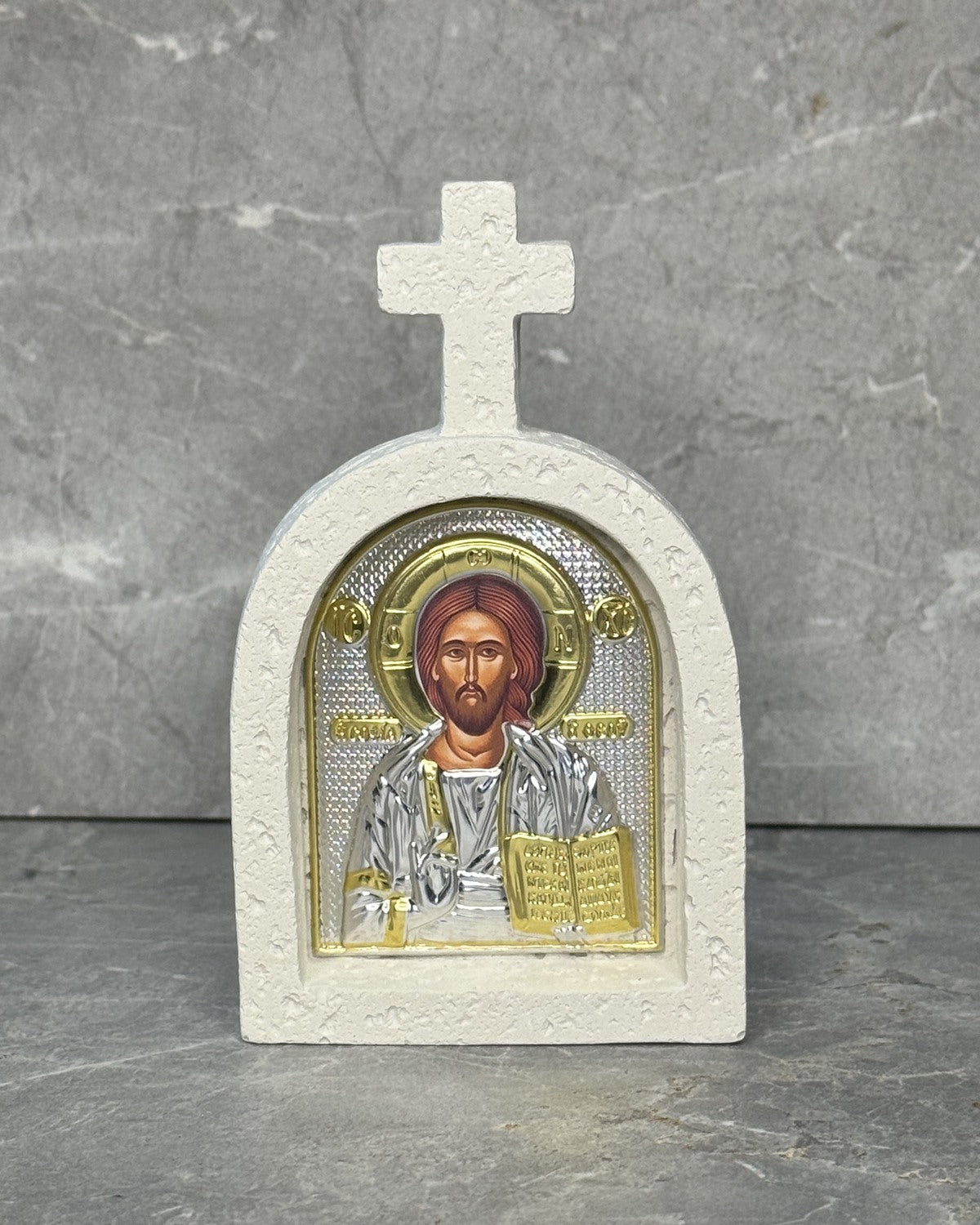 White stone cross icon with Christ Pantocrator icon of Jesus