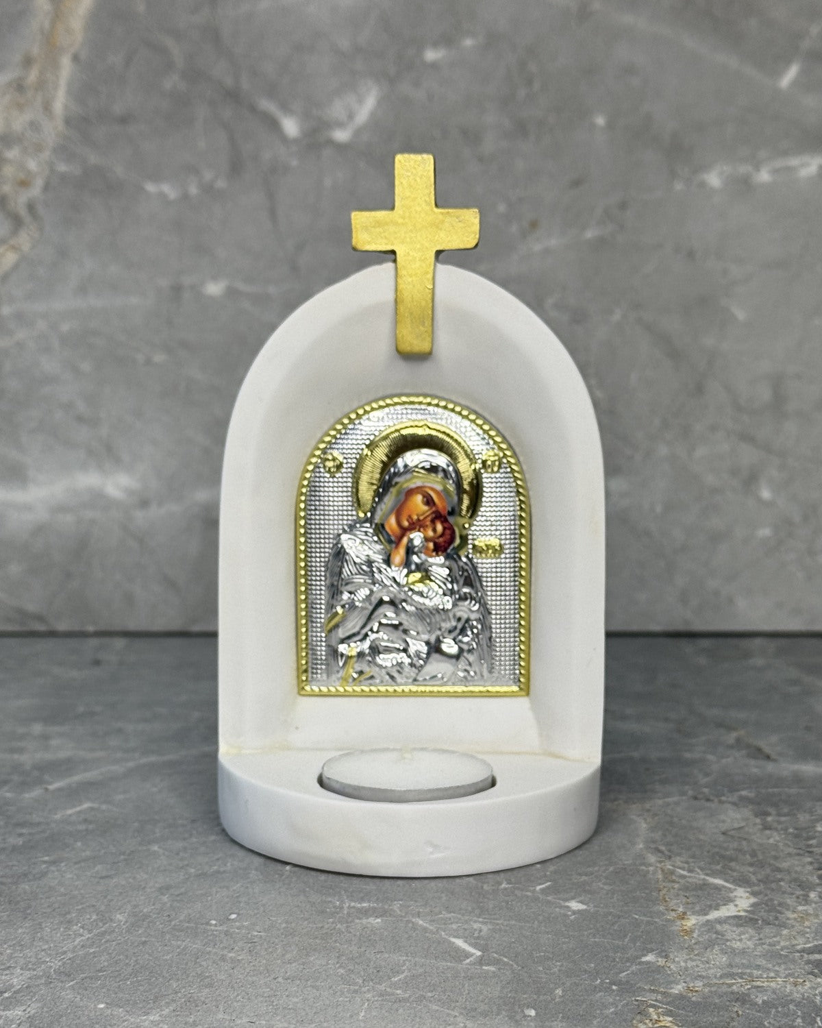 White stone Orthodox candle altar with Glykophilousa icon of Mother Mary and Jesus