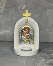 White stone Orthodox candle altar with gold cross and Holy Family icon