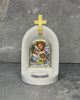 White stone Orthodox candle altar with gold cross and Holy Family icon