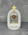 White stone Orthodox candle altar with Christ Pantocrator icon of Jesus