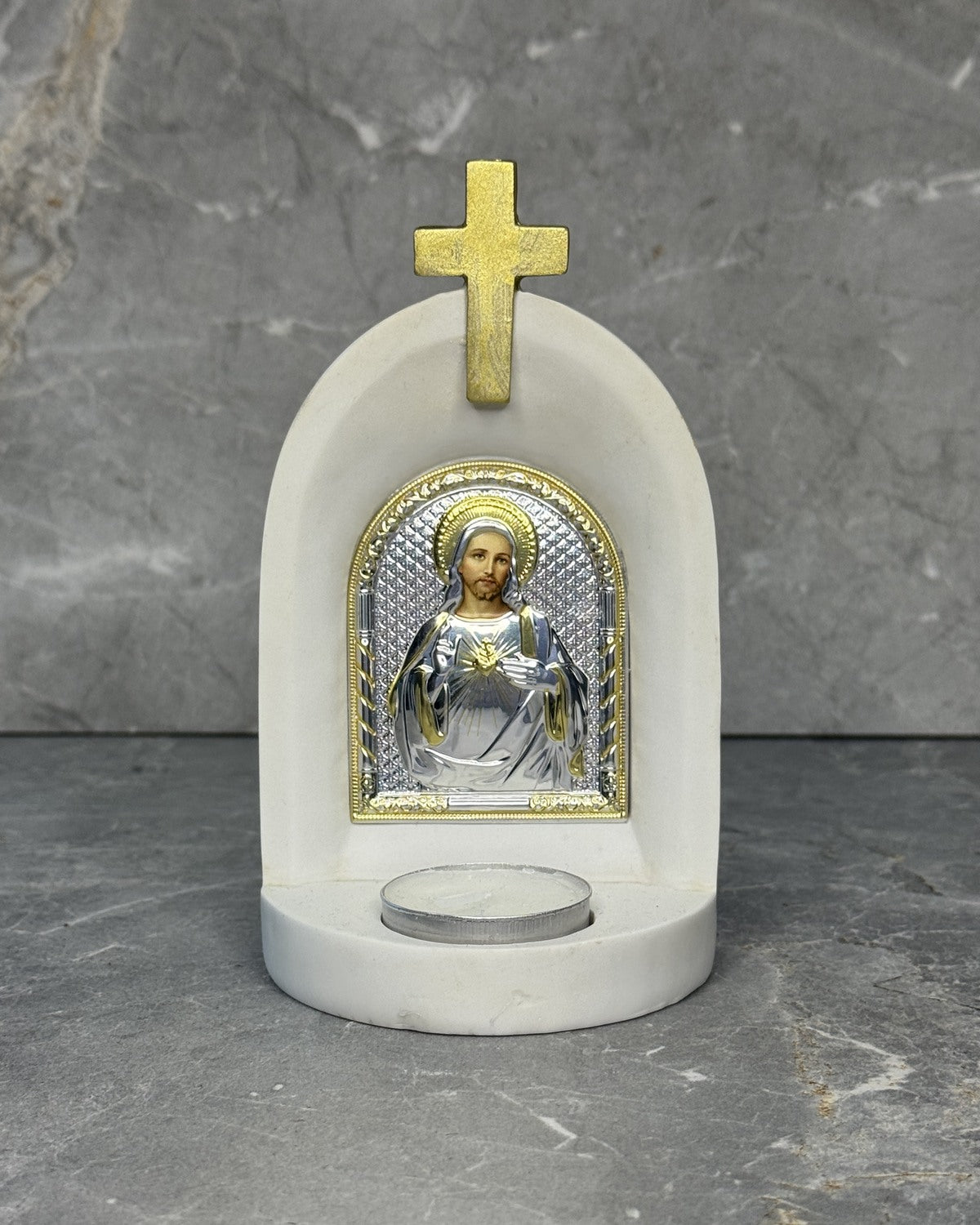 White stone candle altar with Sacred Heart of Jesus icon