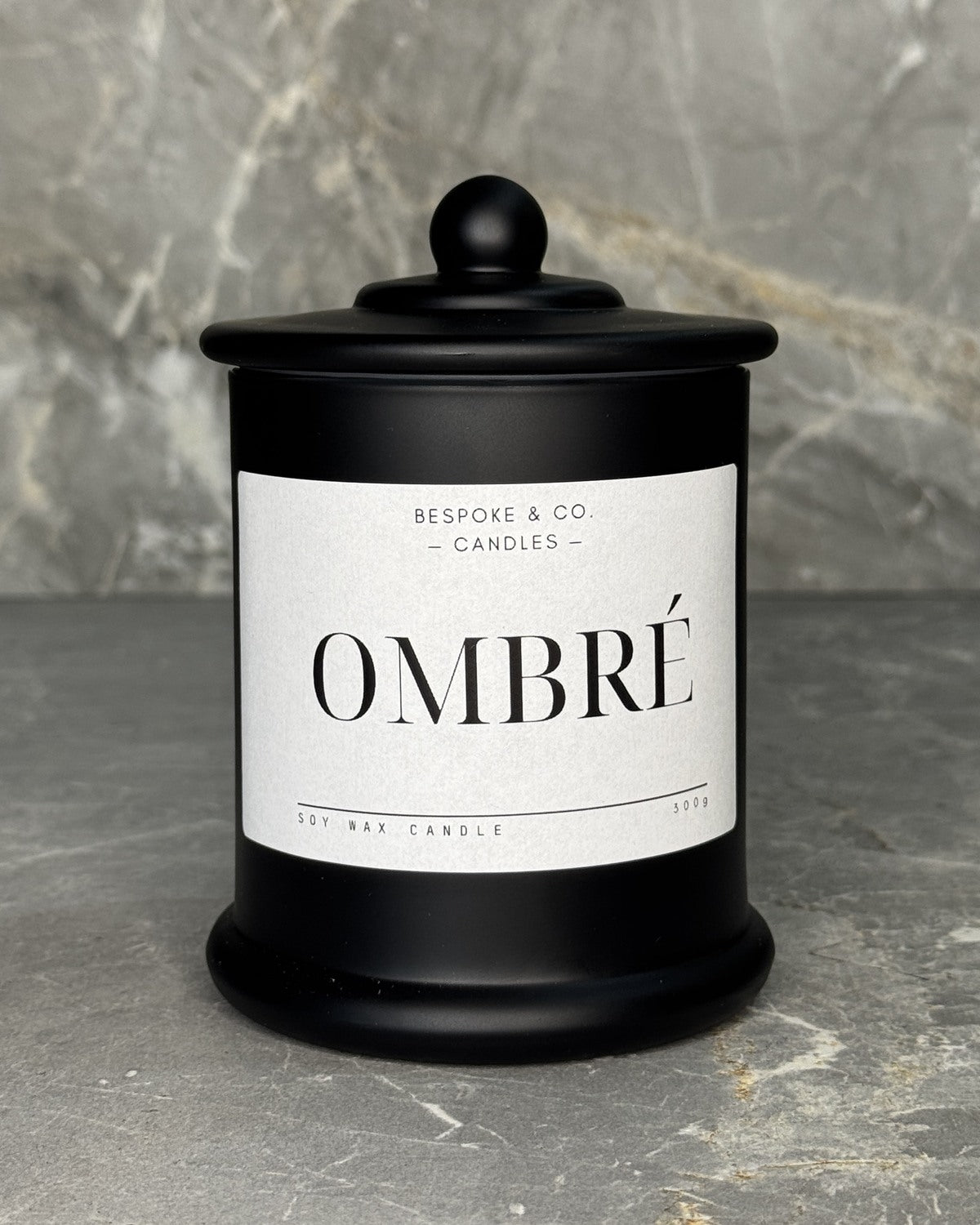 Ombre soy wax candle in a black glass jar with domed lid